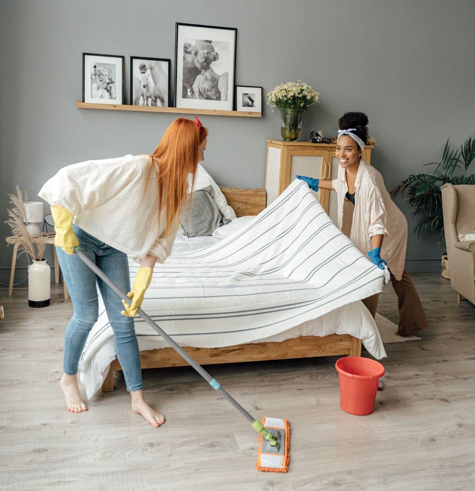 Two women cleaning a room with Kleen Green™.